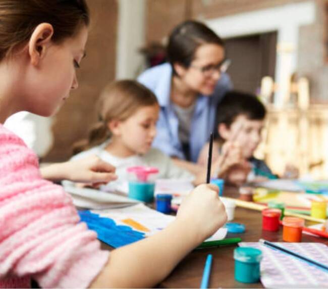 A care worker teaching children's
