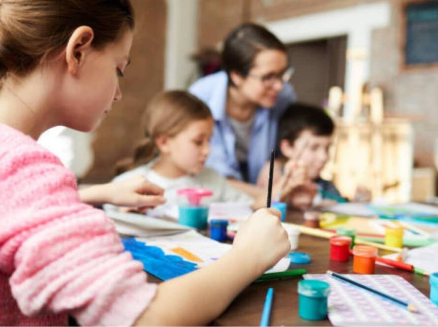 A care worker teaching children's