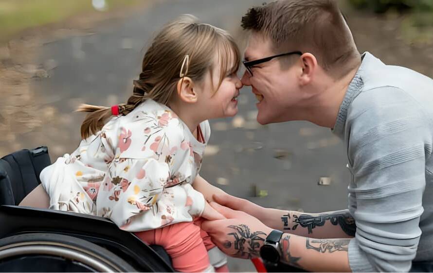 A care worker is laughing with a baby