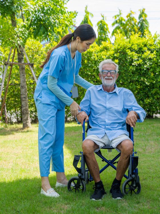 Happy nurse take care senior man on wheelchair at nursing home,Nurse assisting senior age.